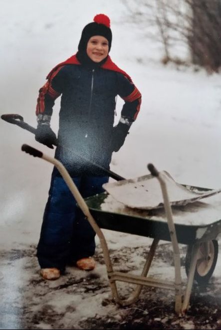 Ken shoveling snow as a child.